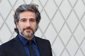Mature elegant professional standing outside the office with copy space