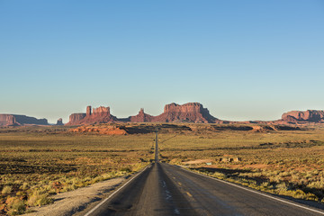 View of Monument Valley canyons during sunrise with Road in Arizona