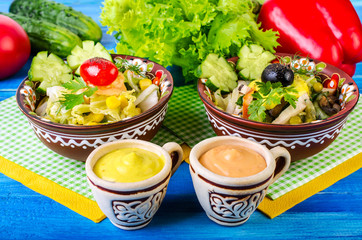 Salad with vegetables, olives and sauce.