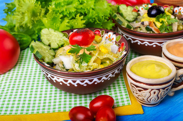 Salad with vegetables, olives and sauce.
