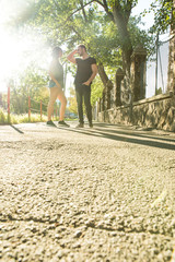 Young couple talking in the sunset in a urban environment