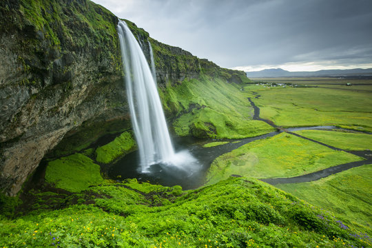 view to waterfall and green valley in Iceland