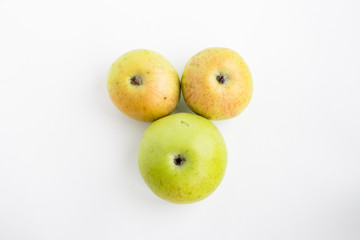 Three apples on a white background green red