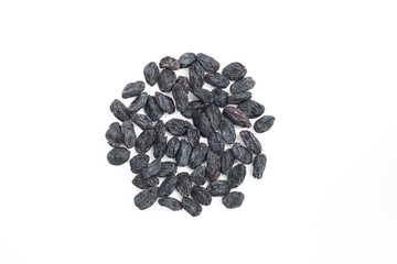 Black raisins on a white background