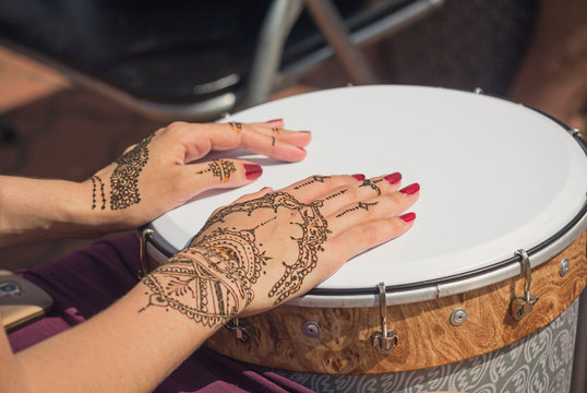 Women's hands decorated with traditional Indian painting on the