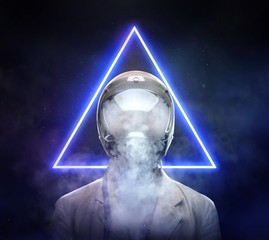 Male in astronaut space helmet smoking electronic cigarette. © Fxquadro