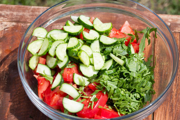 fresh vegetable salad in a plate on a wooden table