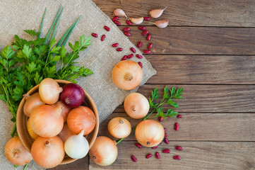 Onion in bowl on sacking and  wooden background