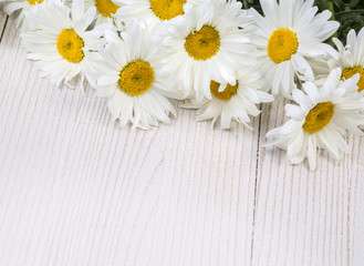 Fototapeta na wymiar Chamomile flowers on wooden