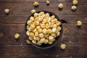 Caramel Coconut Popcorn in Bowl on rustic wooden Table