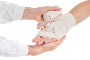 Doctor imposes an elastic bandage to the patient's hand