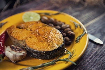 Baked salmon steak with stir-fry veggies. Viewed from above.