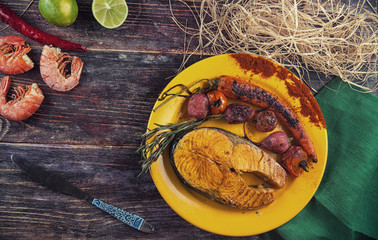 Baked salmon steak with stir-fry veggies. Viewed from above.