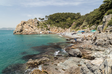 Fototapeta premium View of rocky coastline, cliff and pebble beach at the Taejongdae Resort Park in Busan, South Korea.