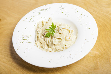 Pasta fettuccine alfredo with chicken, parmesan and parsley