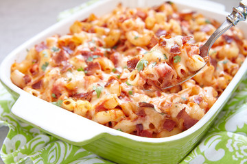 Pasta casserole with bacon, ham, cheese and tomato