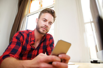 Handsome middle age man texting on smart phone