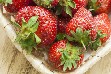 Strawberry fruit lying in basket. The view from the top.