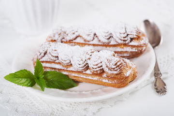 Eclairs on plate on a table