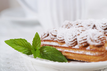 Eclairs on plate on a table