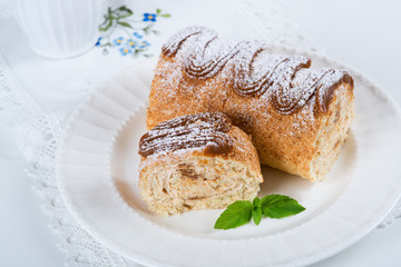 Biscuit roll with condensed milk, selective focus