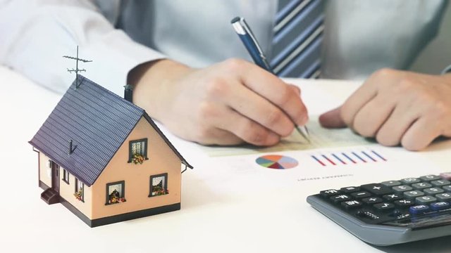 Businessman calculate the cost of building and maintaining home 