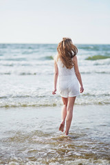 Fototapeta na wymiar Young woman enjoying her vacation by sea