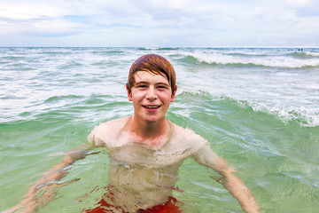 teenager with red hair enjoys  swimming