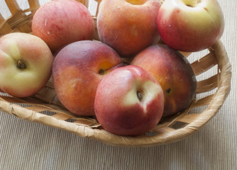 Basket with peaches on a table