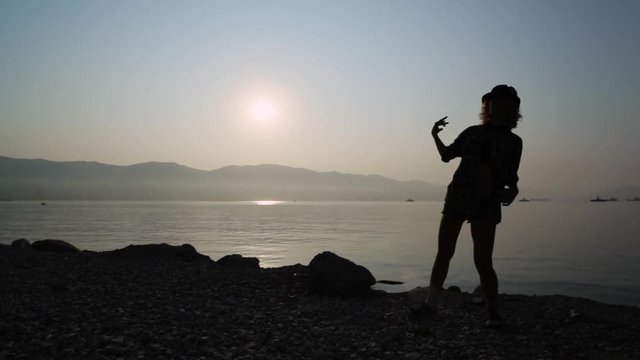 silhouette of a dancing teen girl at sunrise