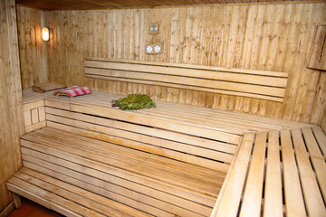 Bath house wooden room  with broom grass and towel.