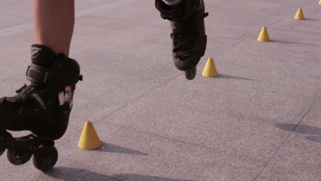 Young Beautiful Girl Rollerblading In A Park.