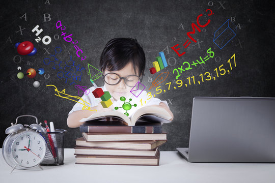 Child studying with books and formula