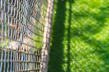 blur green glass with partition in sport field for background.