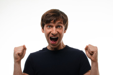 Close up portrait of european man in black t-shirt on neutral white background with angry facial expression. Hard emotion on human face. Football fanat at goal moment. Boy ready for fun and action.