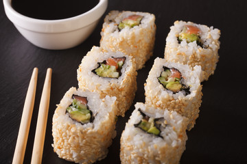 Delicious california rolls with soy sauce closeup. horizontal
