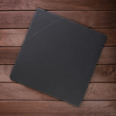 stone slate board on rustic wooden background