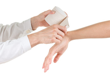 Doctor imposes an elastic bandage to the patient's hand