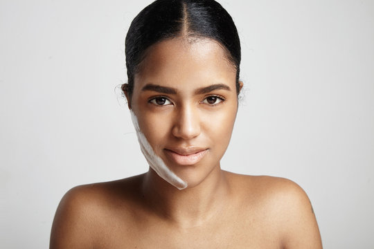 closeup portrait of woman with a fase cleansing foam on the chee