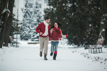 beautiful young couple running in the park