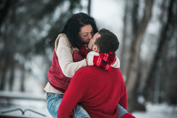 Beautiful young couple kissing in the park