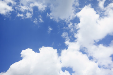 the white clouds floating on a background of blue sky