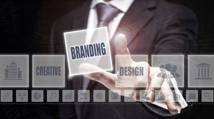 Businessman pressing a Branding concept button on a dark background