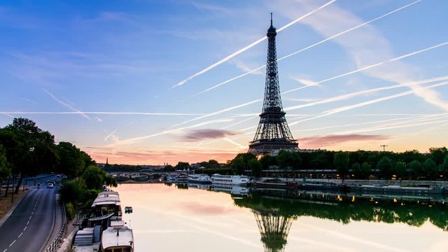 PARIS - AUG 14: Sunrise of Eiffel Tower from Bir Hakeim Bridge and seine river and the blue sky with the cloud from airplane on August 14, 2016. The Eiffel tower is the most visited monument of France