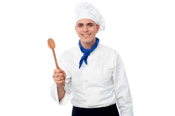 Naklejka premium Chef displaying kitchen utensil.