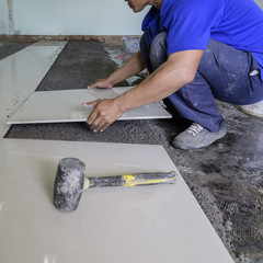 Home improvement, renovation - handyman laying tile, trowel with - 118222018
