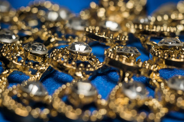 Golden Necklace on Blue Background