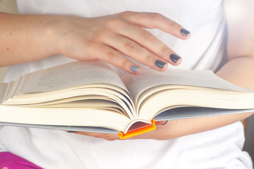 Young girl reading an open old book. Knowledge, Science. Toned image.