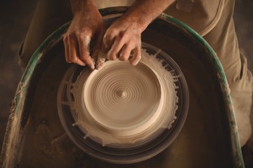 Hands of potter making a pot
