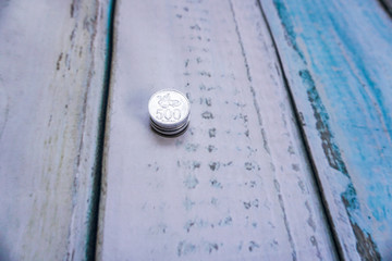 Foreign currency coins on wooden floor